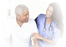 A nurse assists an elderly man with a warm smile.